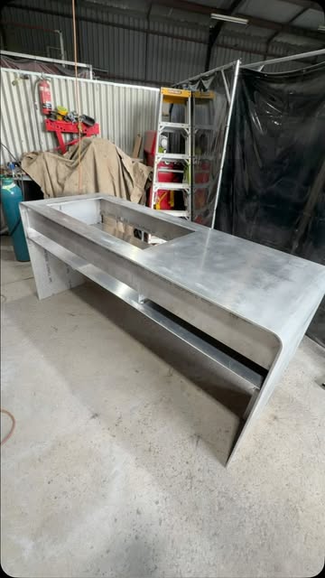 Large fabricated aluminium bench with a folded apron, finished on the workshop floor in Bomaderry.
